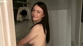 Lexi, a sexy teenage girl, smiling at you while she pleases herself