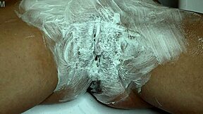 Closeup trimmer razor shave smooths juicy pussy bare