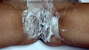Closeup trimmer razor shave smooths juicy pussy bare
