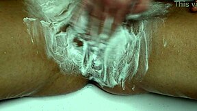 Closeup trimmer razor shave smooths juicy pussy bare