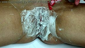 Closeup trimmer razor shave smooths juicy pussy bare