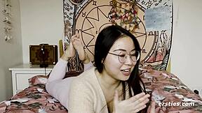 Cute chinese girl with glasses spreads shaved pussy clit for vibrator masturbation