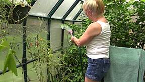 Rae Hart's huge wet tits glisten as she waters garden in milf tease