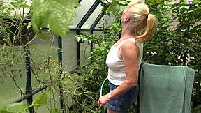 Rae Hart's huge wet tits glisten as she waters garden in milf tease