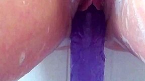 milf soaks in bath thrusting big purple 12-inch dildo till she cums hard