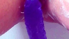 milf soaks in bath thrusting big purple 12-inch dildo till she cums hard