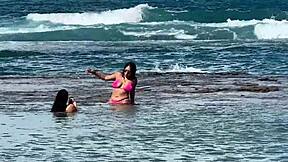 two pretty latinas kiss big asses on public beach