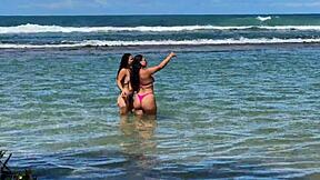 two pretty latinas kiss big asses on public beach