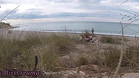 French teacher slut flashes small tits on nude beach, sucks stranger's monster cock publicly with cumshot