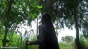 skinny african tribe girl squats in forest making traditional medicine with her pussy skills outdoors.