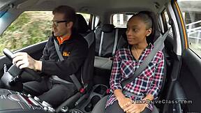 Lesbian student sneaks oral pleasure in a driving car on hidden cam for voyeur spying thrill.