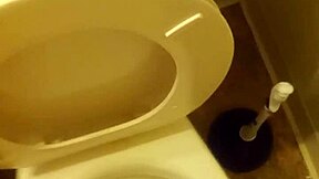 21-year-old stands over toilet pissing while penis slightly peeks out