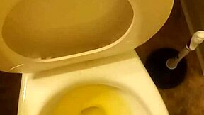 21-year-old stands over toilet pissing while penis slightly peeks out