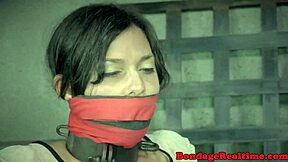bound bdsm sub chokes on deepthroat dildo while tied to poles