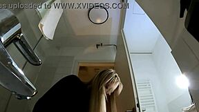 Big tits big ass hot blonde babe in pantyhose and high heels with a miniskirt does a striptease in the bathroom