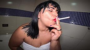 Naughty girl in motel bathtub plays with herself and smokes