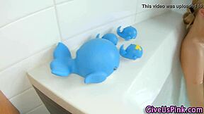 Blonde babe inserts dildo in bath