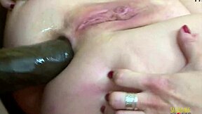 mature blonde moans loud while riding a big black cock in bed