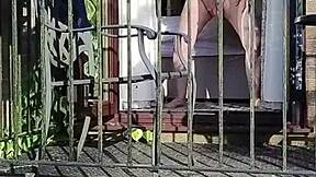 naughty girl enjoys wanking in full view on the balcony