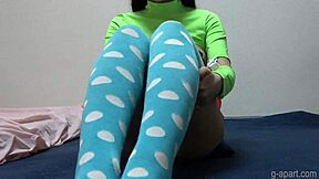 Japanese girl in miniskirt and high socks exercises with her micro thong panties