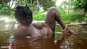 Thick african woman teases naked by the river