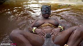 Thick african woman teases naked by the river