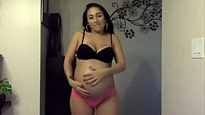 Pregnant cutie shows sexy belly