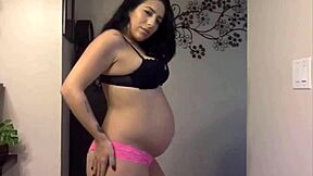 Pregnant cutie shows sexy belly