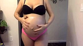 Pregnant cutie shows sexy belly