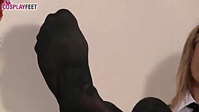 In black dotted stockings plays with her feet