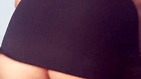 Young girl dances intensely in mini dress with plug