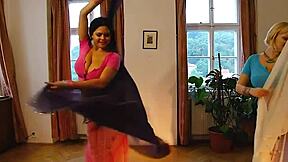 Two curvy belly dancers perform a sensual striptease revealing their natural beauty
