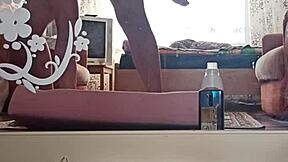 Kazakh couple creates intimate home video together in their private space.