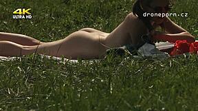 Young girl with small 18+ tits masturbating on the grass