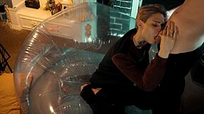 two sweet guys share an inflatable chair for fun