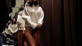 A tanned petite girl next door risks public masturbation in fitting room for orgasm