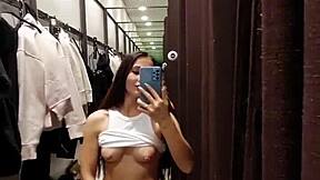 A tanned petite girl next door risks public masturbation in fitting room for orgasm