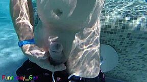 Gay guy cheekily jerks off fat cock in public thermal pool underwater
