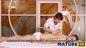 Mature woman and young client enjoy a relaxing massage at the parlor