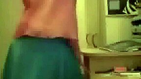 Young blonde teen performs striptease on webcam, undressing and ripping clothes to show her pussy.