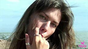 Beach babe Juliette fingers her tight cunt to explosive climax