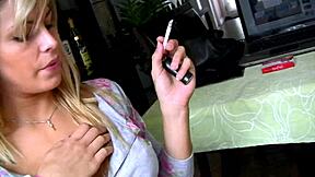 blonde teen teases in ripped clothes while smoking and moaning