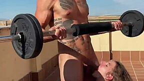 Skinny teen helps a gym bro with his workout