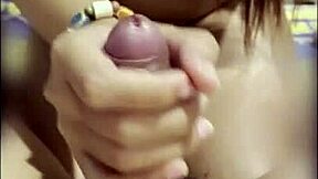 asian thai teen keeps stroking boyfriend's cock after cumshot