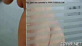 pretty young woman relaxes alone by gently touching herself in a private moment. she uses a dildo to ease the itch