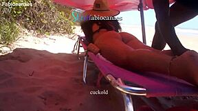 Hey, watch this ebony guy massage a married milf right on the beach