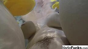 Sexy Nadia enjoys a playful bath with rubber duckies