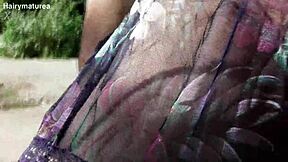 Chubby Hairy Mature Woman in Transparent Dress Exposes Her Beaver in Public Outdoor Setting