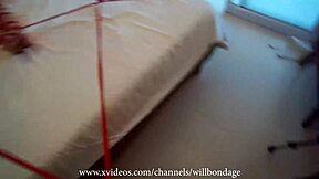 Sofi bound and gagged with red ropes on bed pov