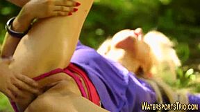 Pretty woman urinated on outdoors